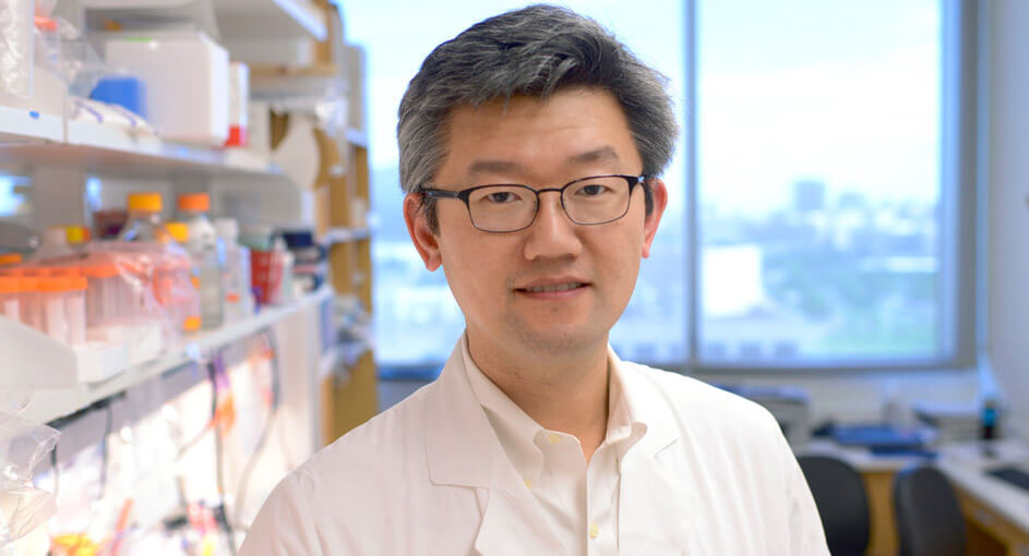 Dr. Hao Zhu standing in the lab.